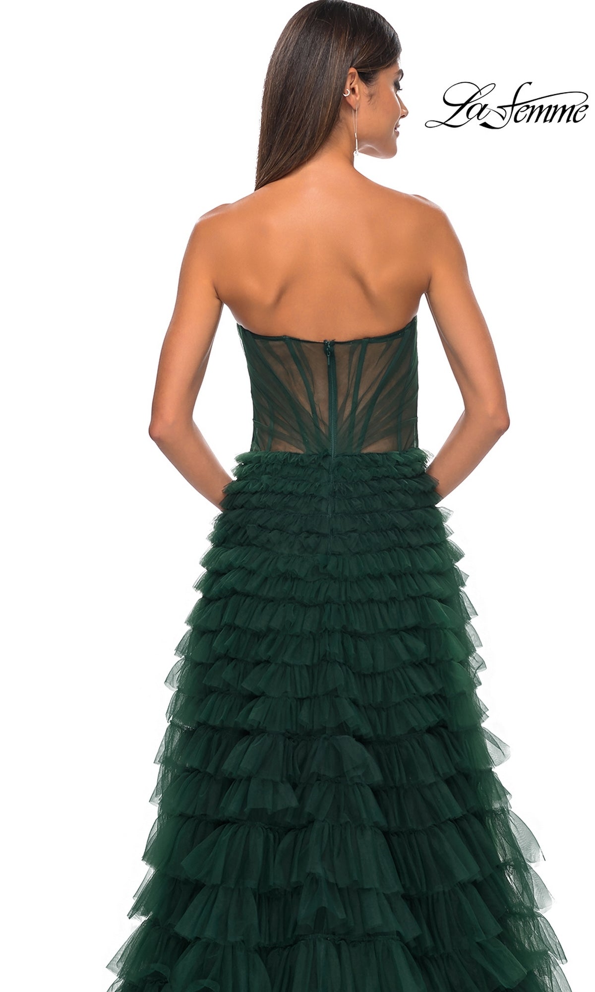 Woman wearing the La Femme Strapless Long Ruffled Prom Dress 32283 in dark green tulle, seen from the back with long straight hair and hoop earrings. La Femme logo displayed in the top right corner.